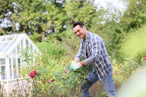 Overgrown garden waste being removed from a Highbury property